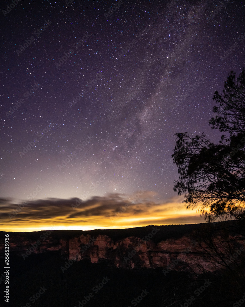 Milkyway rising over a mountain ridge with clouds on the horizon Milkyway rising over a mountain ridge with clouds on the horizon