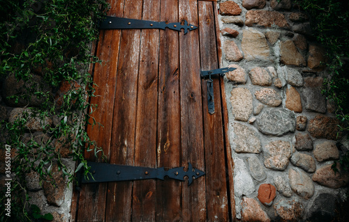  Large old wooden door on a stone wall