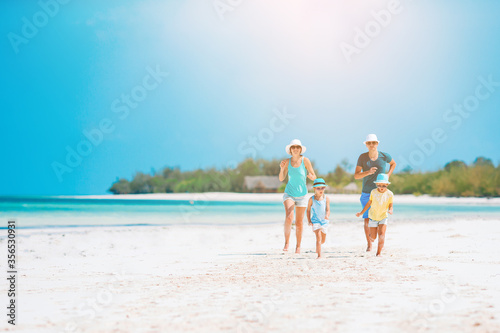 Photo of happy family having fun on the beach. Summer Lifestyle