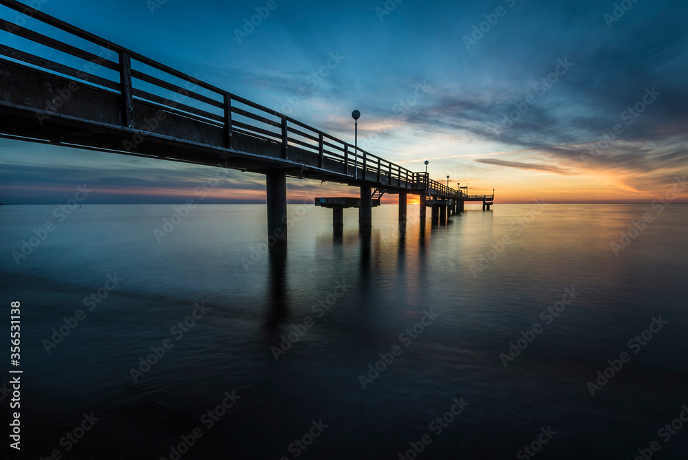pier on the baltic sea at sunset