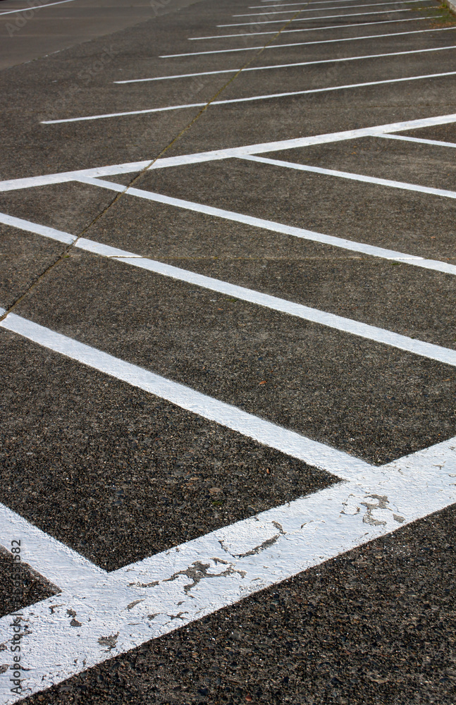 Fototapeta premium Abstract shots of parking lot with white and yellow stripes, arrows, signs, and symbols