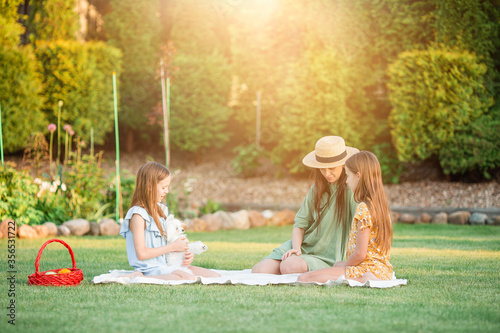 Happy mother and little daughers relax in suumer photo