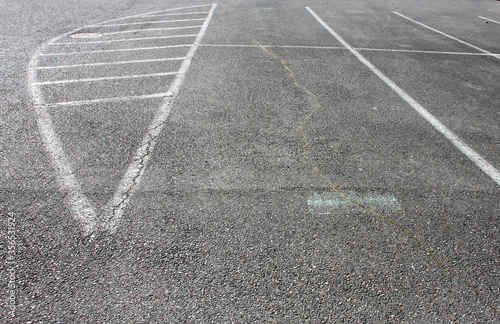 Abstract shots of parking lot with white and yellow stripes, arrows, signs, and symbols