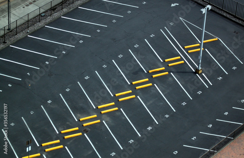 Abstract aerial shots of parking lot with white and yellow stripes and signs