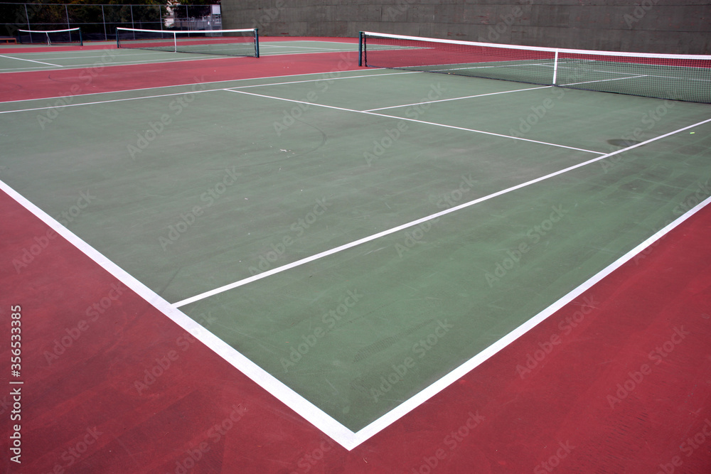 Various angles of green tennis courts with white stripes and nets