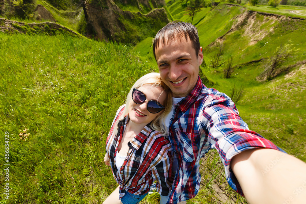 Two hikers taking selfie on top of the mountain