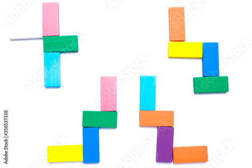 A flatlay picture of colourful wooden block arrange on isolated white background. Children education and development concept.