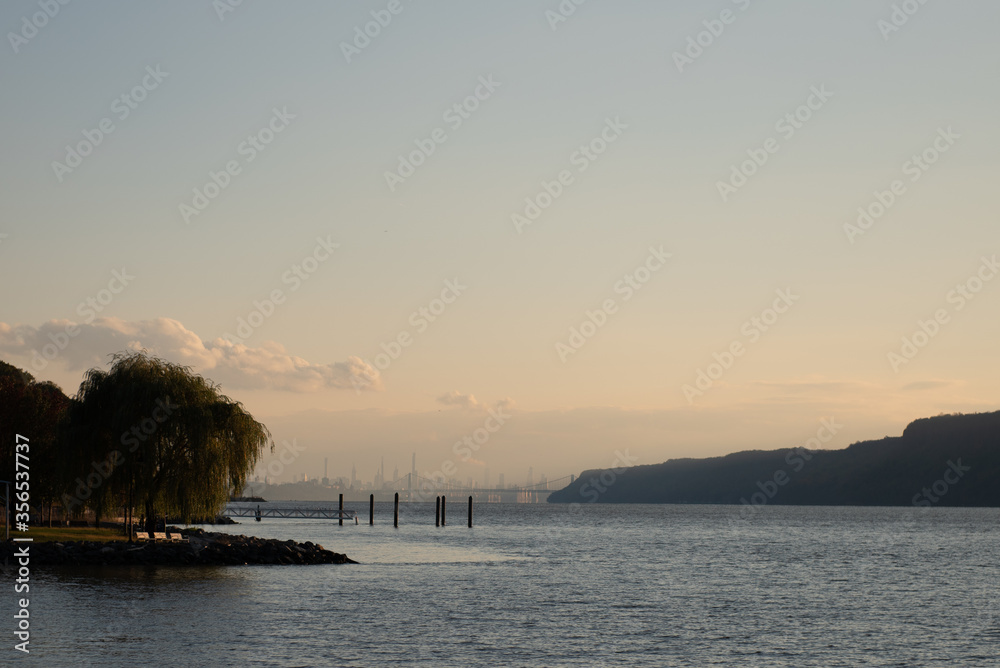 The New York City skyline, George Washington Bridge, and the Hudson River as seen from Dobbs Ferry, New York, USA in November.