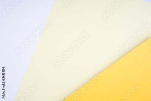 Creative arrangement of soft pastel colored papers creating an abstract background