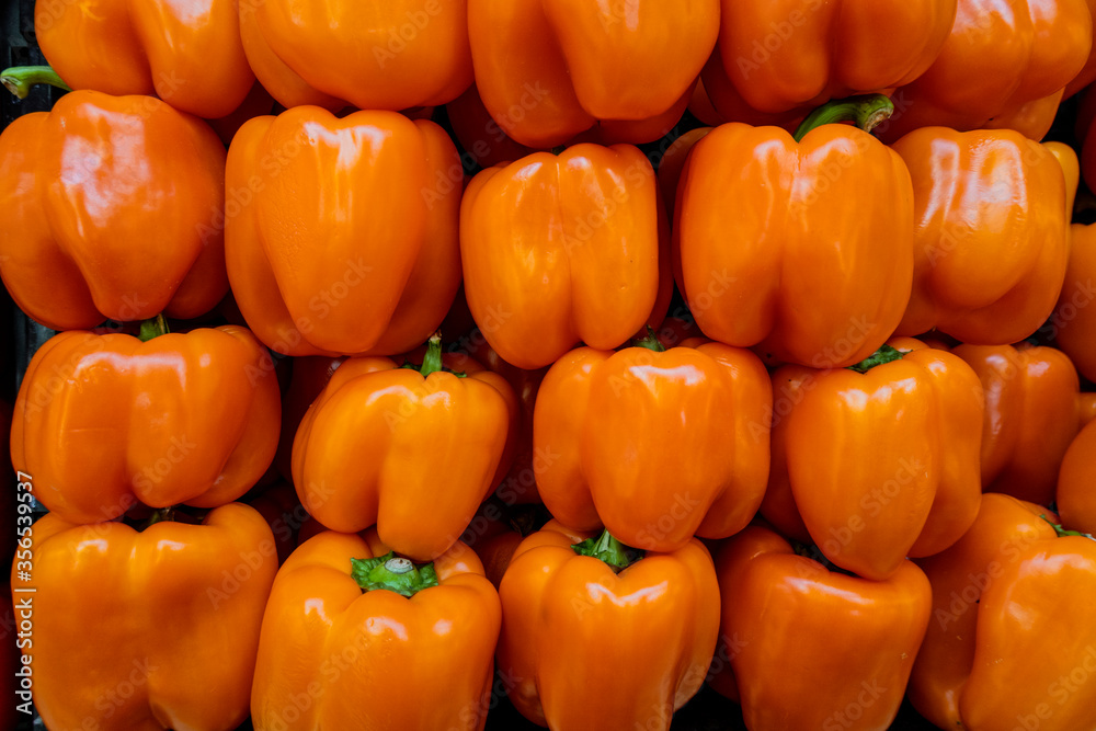 Orange bell peppers in a pile ready for sale. Orange bell peppers in a pile ready for sale.