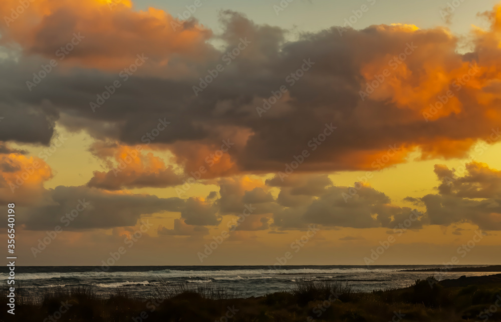Landscape scenery of colourful sky with heavy clouds at sunset in Australia.