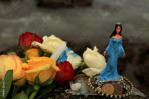 salvador, bahia / brazil - february 2, 2020: image of yemanje, candomble entity is seen on the rio Vermelho beach, in the city of salvador, during religious celebration. photo