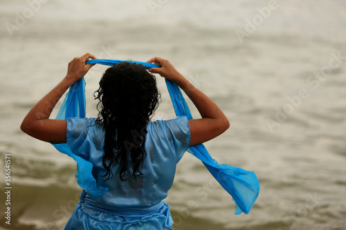 salvador, bahia / brazil - february 2, 2020: devotees and admirers of the orixa yemanja, a candomble entity, seen on the rio Vermelho beach, in the city of salvador, during a religious celebration. photo