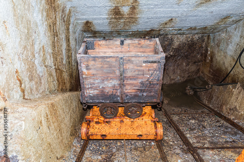 Old mining cart inside mine .