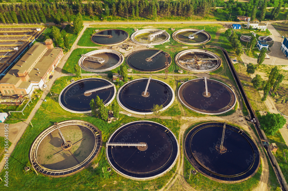 Wastewater treatment plant, round pools for filtration of dirty or sewage water, aerial view Wastewater treatment plant, round pools for filtration of dirty or sewage water, aerial view