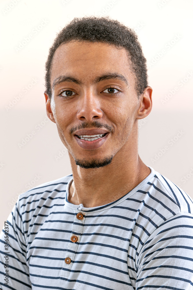 Obraz premium Head and shoulders portrait of young African American man sailor shirt smiling business man