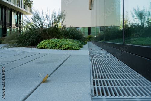 Day view of joining the foundation, paving, storm sewer, and gravel and glass facade and building material texture modern architecture and the center of the city of Vienna, Austria 
