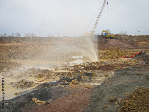 burst water pipe in real process of construction on a building site, laying orange pipes, debris, trench, view of underground utilities, dug pipes, pouring the foundation, Rusted gas, and oil pipeline