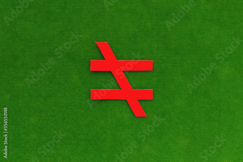 An equal sign crossed out on a green background. The concept of inequality, injustice, discrimination.