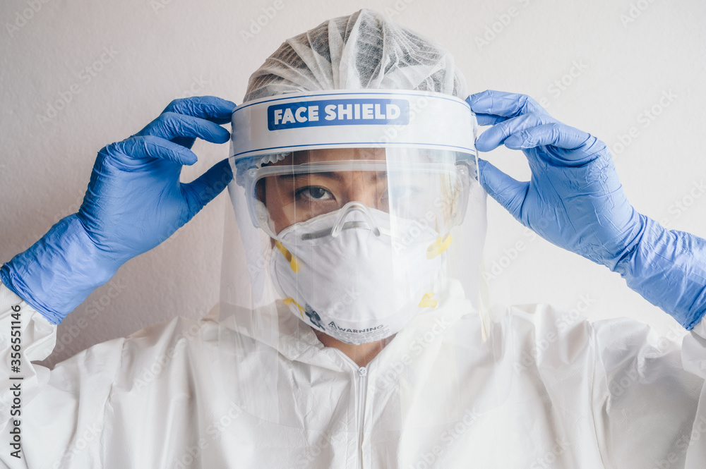 Healthcare worker wearing PPE suit for working in hospital during Covid