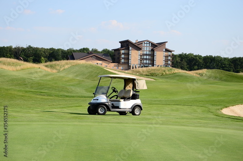 Green grass and golf car on golf course