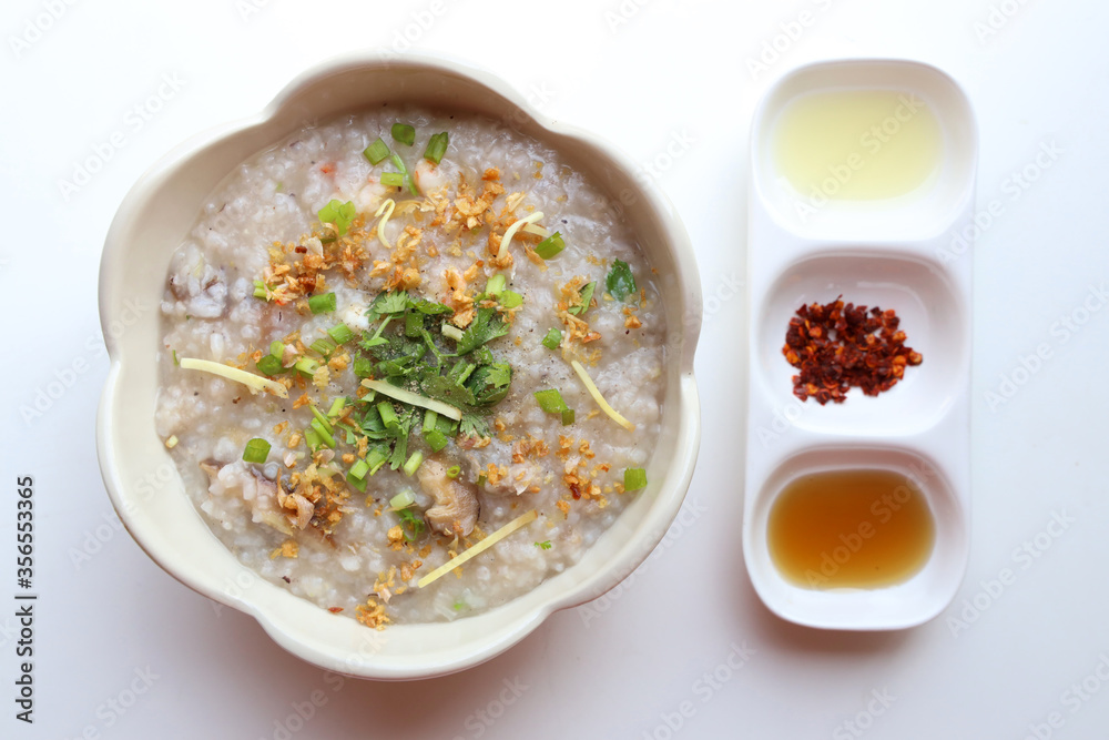 Closeup Rice porridge machine Served in a white bowl With condiments, chillies, sugar, fish sauce, lime Closeup Rice porridge machine Served in a white bowl With condiments, chillies, sugar, fish sauce, lime