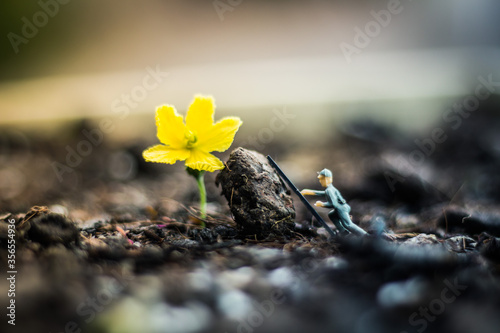Miniature people team works to inspect and plant trees for a green world project. (We plant trees for a better world)