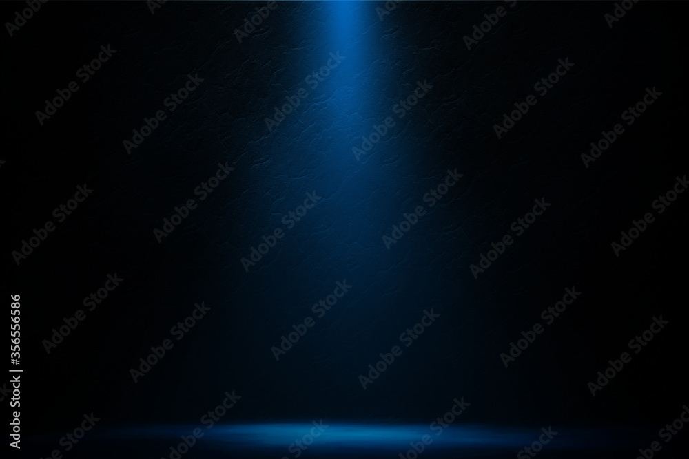Spotlight blue on concrete wall in room night entertainment background.