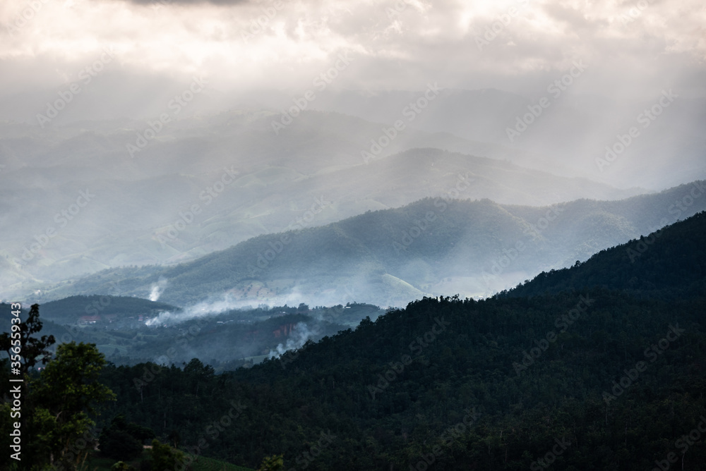 Smoke from cooking rising from the house of the Pakkayo hill tribe in which the house is located in the forest In the mountains