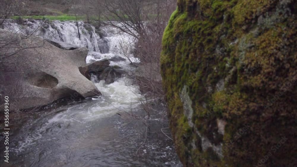 camera movement reveals a waterfall. camera movement reveals a waterfall.