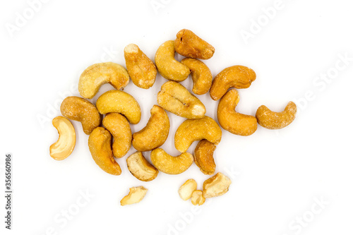 Roasted salted cashew nuts top view isolated on white background