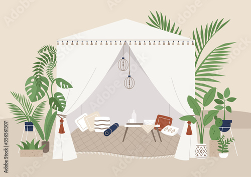 Summer garden tent, outdoor events, boho style marquee with pillows and other decorative elements, beautiful tropical plants