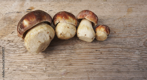Edible peeled mushrooms lie on wooden background, top view 