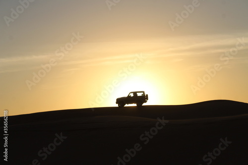 car with sunset in desert Dubai