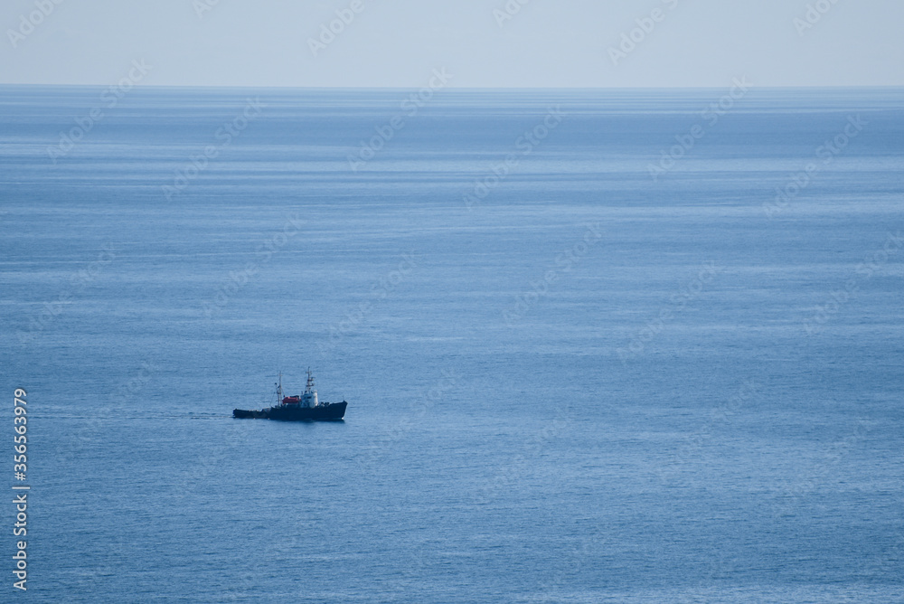The same boat sailing in the calm blue sea The same boat sailing in the calm blue sea