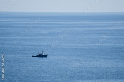 The same boat sailing in the calm blue sea