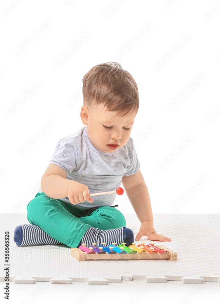 Cute little boy with xylophone on white background Cute little boy with xylophone on white background