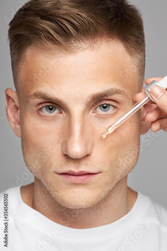  Men's skin care. Facial beauty procedure for the model. Vitamins Treatment for the restoration and renewal of the face. Comedy facial care product.