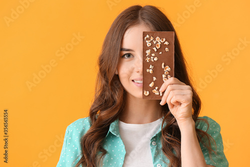 Smiling young woman holding...