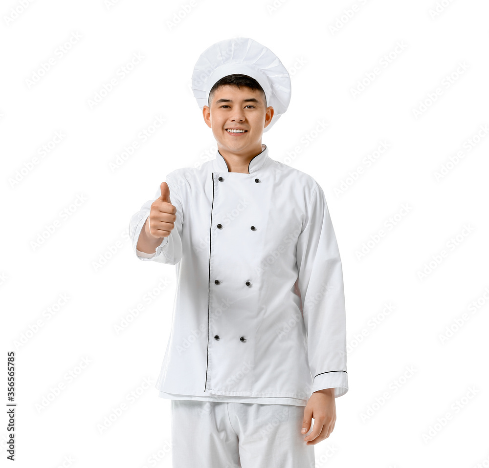 Handsome Asian chef showing thumb-up gesture on white background Handsome Asian chef showing thumb-up gesture on white background
