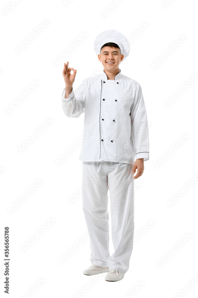 Handsome Asian chef showing OK gesture on white background Handsome Asian chef showing OK gesture on white background