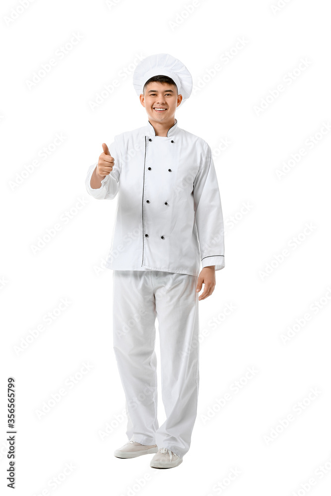 Handsome Asian chef showing thumb-up gesture on white background