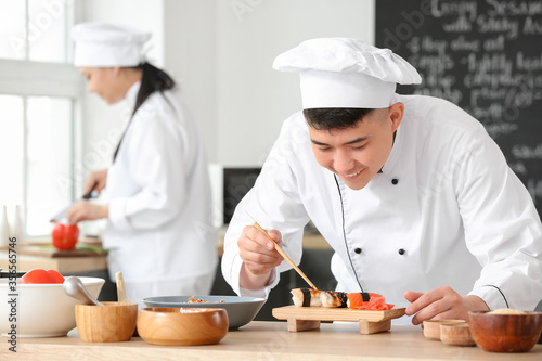 Handsome Asian chef cooking...