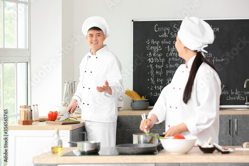 Asian chefs cooking togethe...
