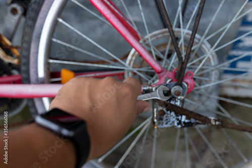 Tightening a bicycle nut with a wrench