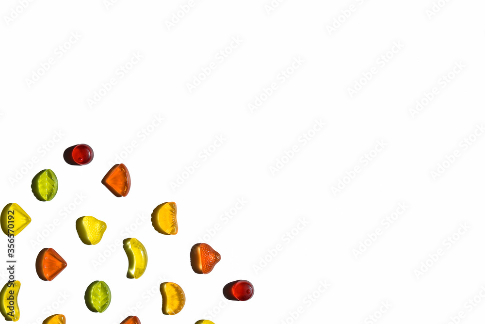 Colorful jelly beans in fruits shapes. Top view of positive and sweet composition on white background, with copy space. Colorful jelly beans in fruits shapes. Top view of positive and sweet composition on white background, with copy space.