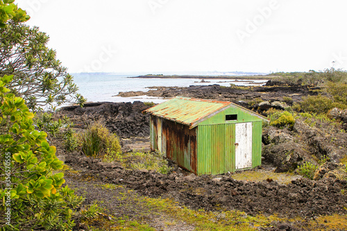 A very old rusty boatshed on an island in New Zealand built in the 1930's. photo