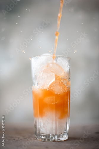 freshly squeezed grapefruit juice with ice in a tall glass