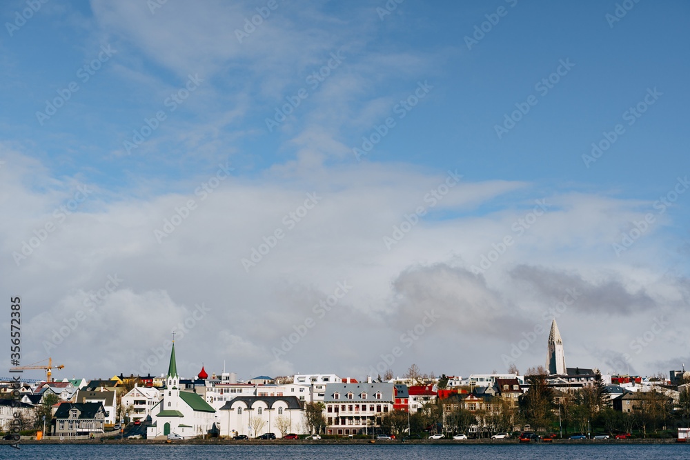 Buildings on the shore of Lake Tjodnin, in Reykjavik, the capital of Iceland.