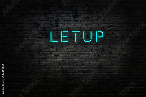 Night view of neon sign on brick wall photo